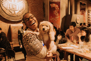 woman laughing holding puppy